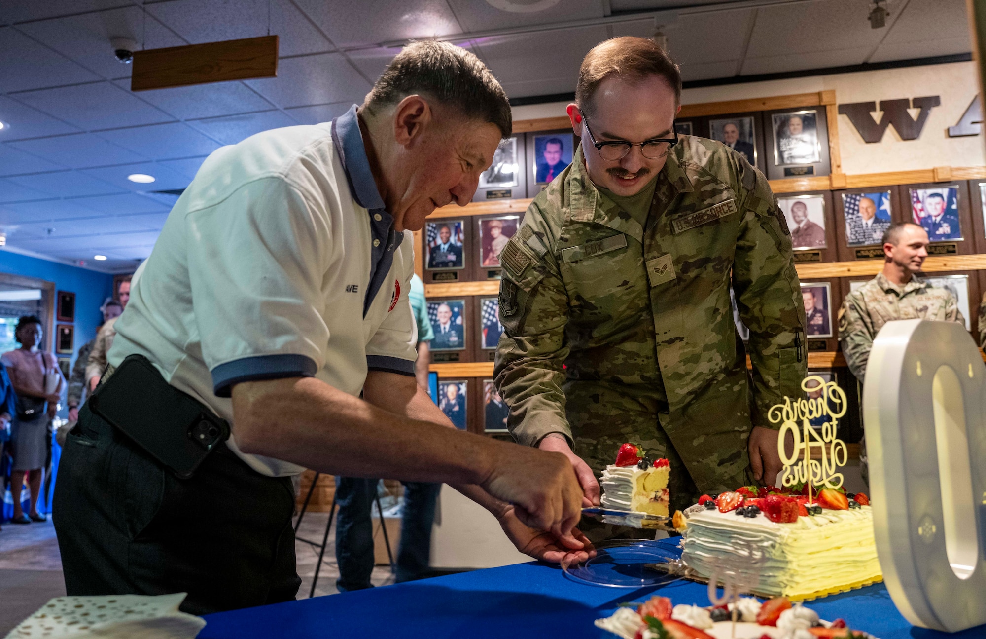 Retired Chief Master Sgt. Dave Hamel, former director of the Air Force Enlisted Heritage Research Institute, and Senior Airman David Cox, AFEHRI administrative specialist and museum technician, cut the cake during the Enlisted Heritage Hall’s 40th Anniversary celebration on Maxwell Air Force Base – Gunter Annex, Ala., May 1, 2026. (U.S. Air Force photo by Brian Ferguson)