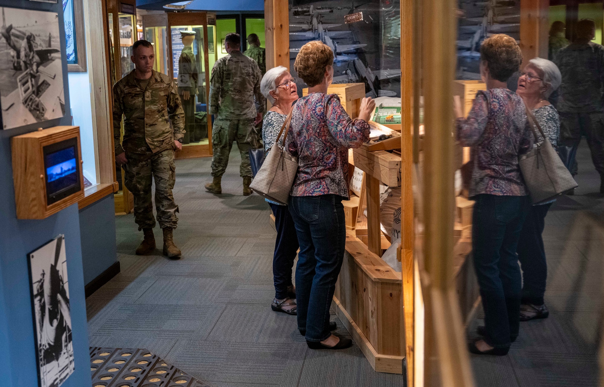 Hilde McGinnis and Angie Jolly look at a display during the Enlisted Heritage Hall 40th Anniversary celebration on Maxwell Air Force Base – Gunter Annex, Ala., May 1, 2026. McGinnis and Jolly are the wife and daughter of retired Chief Master Sgt. Roy C. McGinnis, a 41-year veteran and WWII prisoner of war, who also served in the Korean and Vietnam War. Chief McGinnis died in 2021. His display can be seen in the Alabama Room of the EHH. (U.S. Air Force photo by Brian Ferguson)