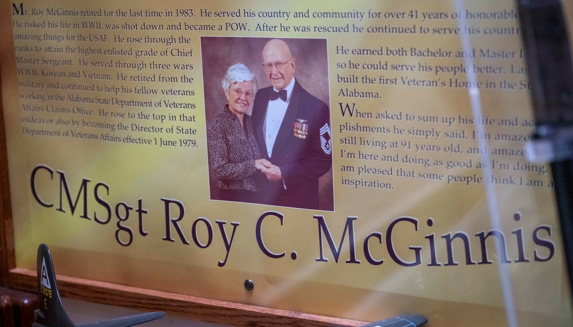 Chief Master Sgt. Roy C. McGinnis was a 41-year veteran and WWII prisoner of war, who also served in the Korean and Vietnam War. His display can be seen in the Alabama Room of the Enlisted Heritage Hall on Maxwell Air Force Base – Gunter Annex. His wife Hilde McGinnis and daughter Angie Jolly were at the Heritage Hall, May 1, 2026, to celebrate its 40th anniversary. Chief McGinnis died in 2021. (U.S. Air Force photo by Brian Ferguson)
