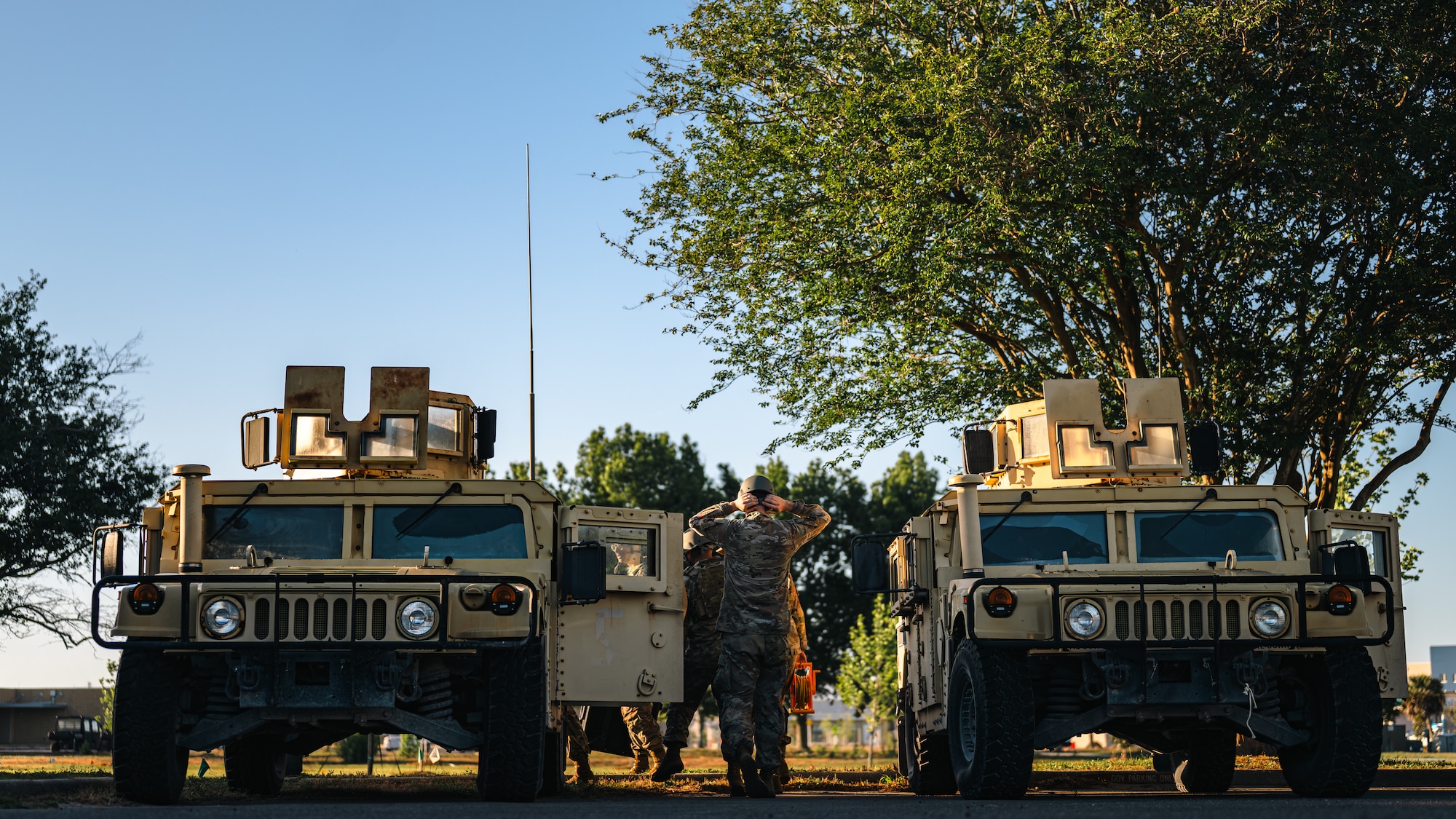 Airmen enter a Humvee