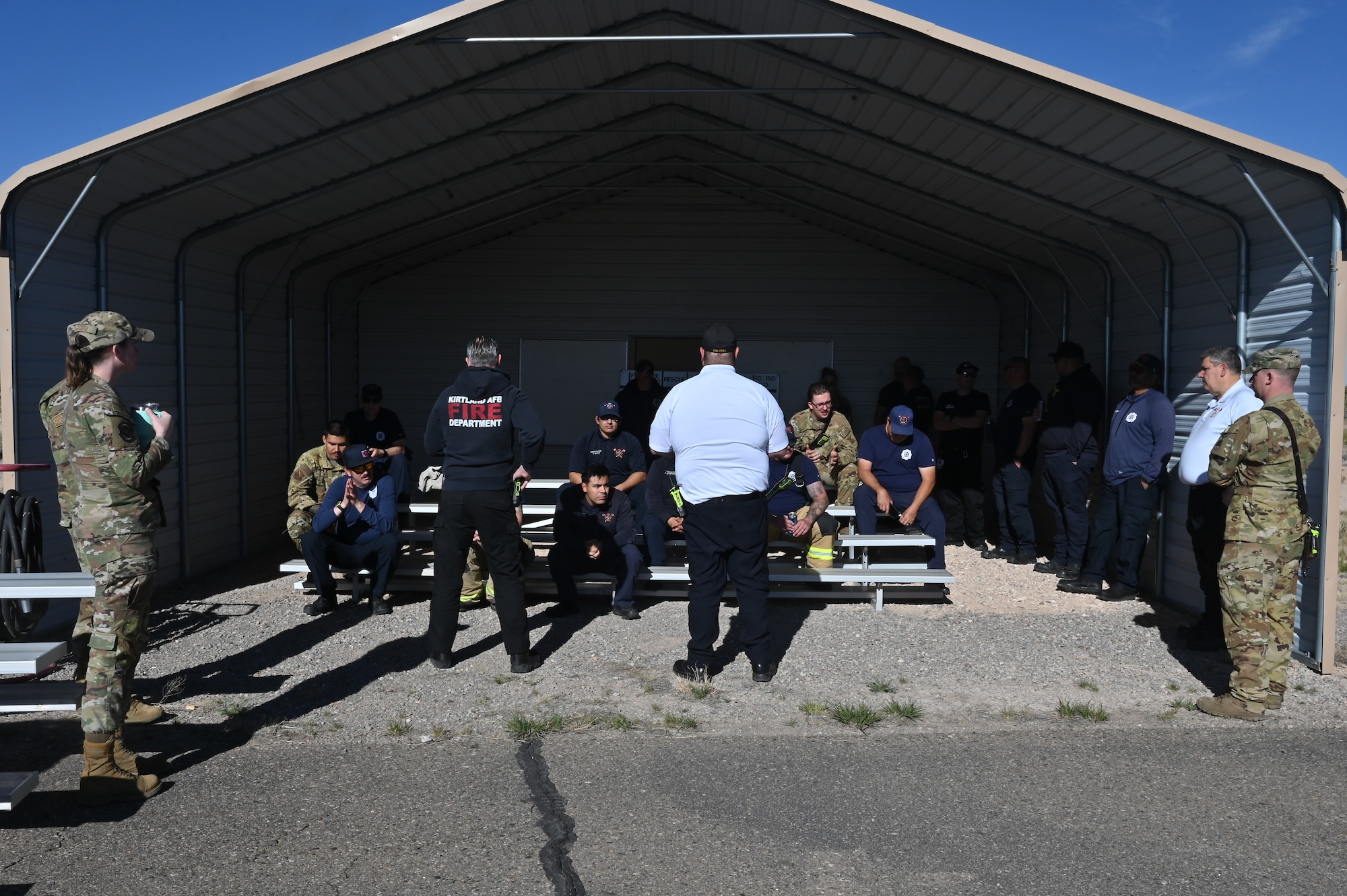 Ryan Murphy, left, 377th Civil Engineer Squadron fire station chief, and Torben Dalstra, 377 Civil Engineer Squadron fire battalion chief, give a safety brief to Team Kirtland fire protection specialists ahead of a Kirtland Air Force Base Fire and Emergency Services (KFES) exercise.