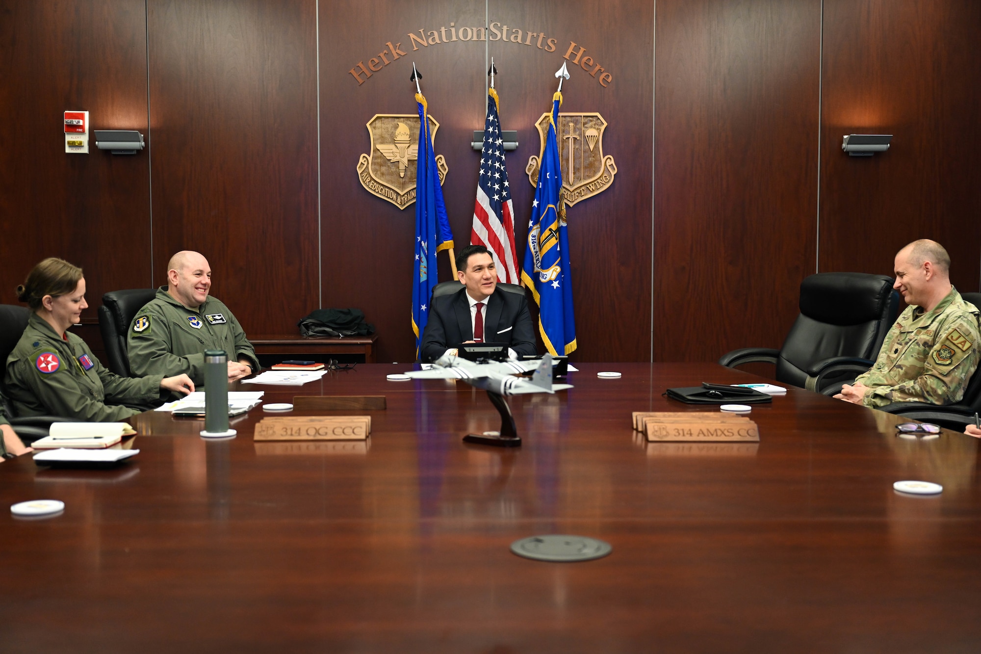 People sit around a large table smiling and talking.