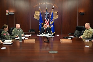 People sit around a large table smiling and talking.