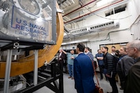 Erik Tejero (second from left), Ph.D., U.S. Naval Research Laboratory (NRL) research physicist, conducts a tour of the Space Chamber during NRL’s Innovation Day for Industry in Washington, D.C., April 28, 2026. The event focused on informing industry and assessing interest in a focused set of emerging technologies that are ready for collaboration with industry partners. (U.S. Navy photo by Sarah Peterson)