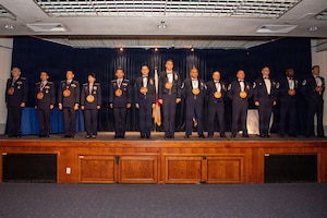 A group of people stand on a stage.