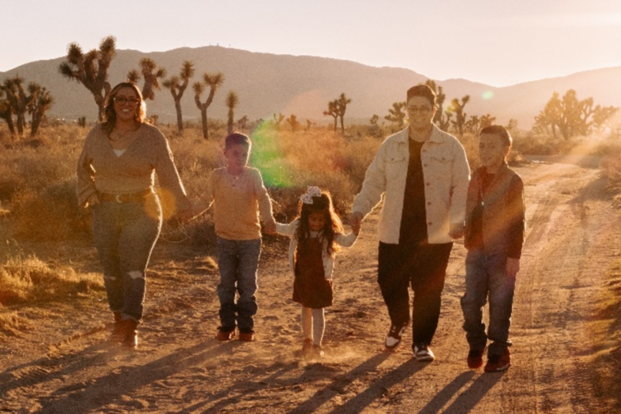 From left, Jacqulyn Lopez, Air Force Test Center executive administrator, Liam G. Lopez, son, Olivia H. Lopez, daughter, Sylvia Lopez, wife to Jacqulyn Lopez, and Maxton Lopez, son, hold hands together while posing for a photo in Lancaster, Calif. November 2025. Lopez credits her family for keeping her motivated, and what keeps her showing up and becoming a better wingman for herself and others.