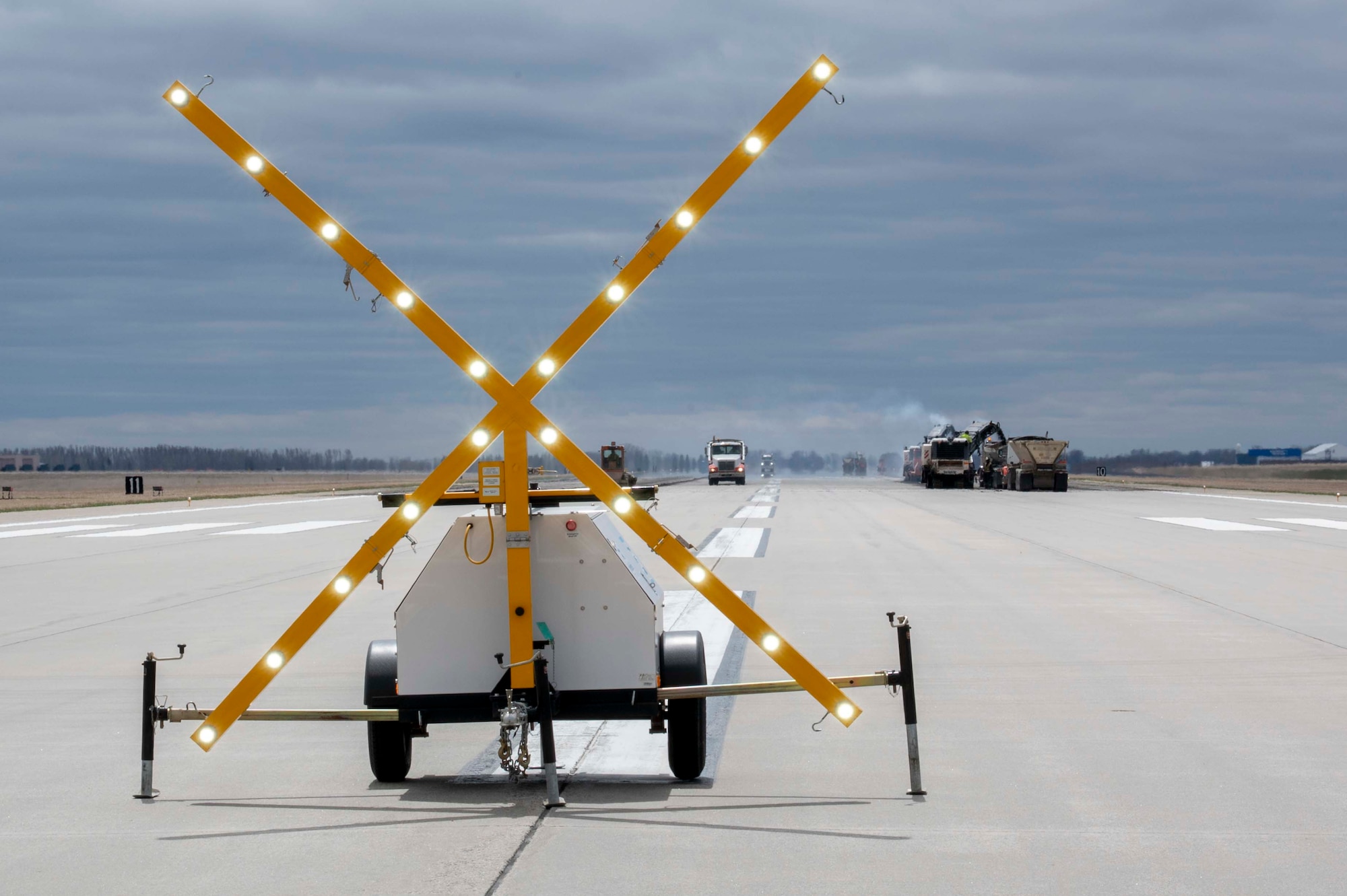 A yellow X sign is lit up on a white truck.