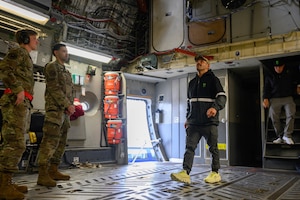 A person is given a tour through a cargo aircraft.
