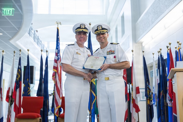 AGANA HEIGHTS (March 27, 2026) – Rear Adm. Kevin J. Brown, commander, Naval Medical Forces Pacific, and director, Defense Health Network Pacific Rim, poses for a picture with U.S. Navy Medicine Readiness and Training Command Guam Commanding Officer Capt. Joel M. Schofer during a change of command ceremony March 27. The ceremony, which was presided over by Brown, marked the transition of leadership to Capt. James. G. Demitrack who will also become the director of U.S. Naval Hospital Guam.