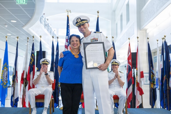 AGANA HEIGHTS (March 27, 2026) – U.S. Navy Medicine Readiness and Training Command (USNMRTC) Guam Commanding Officer Capt. Joel M. Schofer poses for a photo with the Honorable Lou Leon Guerrero, Governor of Guam, during his change of command ceremony March 27. Guerrero thanked Schofer for his partnership and presented him with the Maga'håga Award to honor their collaboration together. The ceremony marked the official transition of leadership to Capt. James G. Demitrack who also became the director of U.S. Naval Hospital Guam.