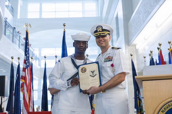 AGANA HEIGHTS (March 27, 2026) – U.S. Navy Medicine Readiness and Training Command (USNMRTC) Guam Commanding Officer Capt. Joel M. Schofer poses for a photo with Hospital Corpsman 3rd Class Issachar R. Punch, March 27. Schofer recognized and meritoriously advanced Punch before the start of his change of command ceremony during which he transferred leadership to Capt. James G. Demitrack.