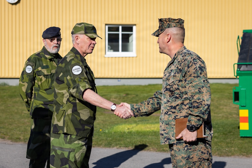 U.S. Marine Corps Lt. Col. Travis Chamberlin, right, commanding officer of Combat Logistics Battalion 24, Combat Logistics Regiment 27, 2nd Marine Logistics Group, speaks with retired Rear Admiral Jonas Wikström during exercise Aurora 26 in Kvarn, Sweden, May 1, 2026. U.S. Marines and Sailors with 2nd MLG are participating in exercise Aurora as part of the larger U.S. Army-led Sword 26 series of linked multinational exercises, which directly supports NATO's Eastern Flank Deterrence Initiative concept, validates defense plans, builds a unified lethal force, and strengthens deterrence. Chamberlin is a native of Ohio. (U.S. Marine Corps photo by Lance Cpl. Brady V. Hathaway)