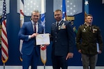 Secretary of War Pete Hegseth presents the Soldier’s Medal to Army Maj. Ryan S. Reynolds, 771st Troop Command Battalion executive officer; and the Airman’s Medal to Air Force Maj. Edwin O. Stanfield, 167th Airlift Wing intelligence officer, during a ceremony at the Pentagon, May 4, 2026. Photo by Navy Petty Officer 2nd Class Carson Croom.