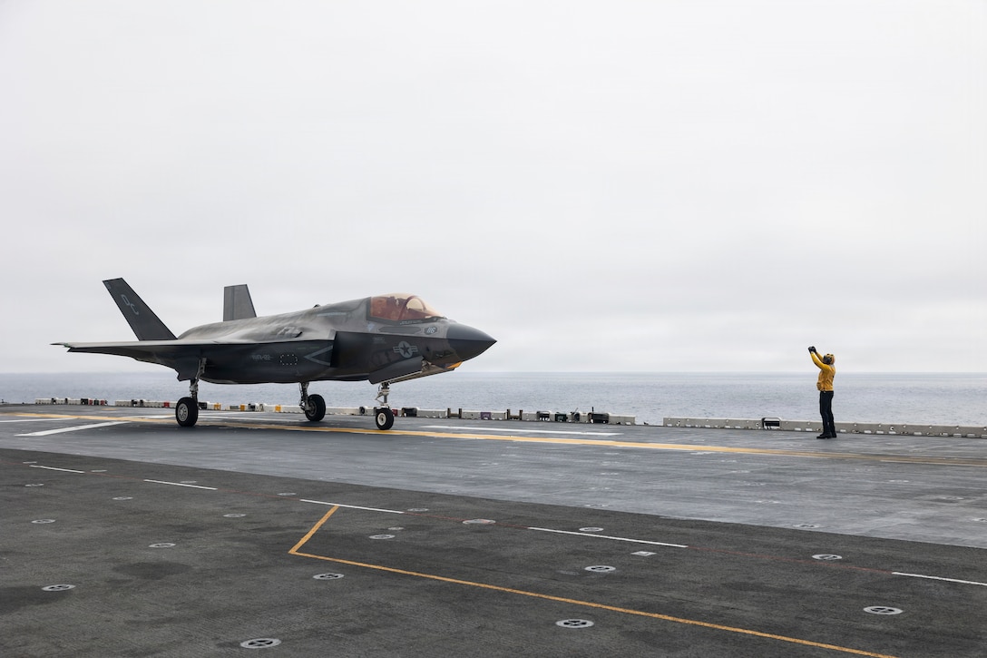 A U.S. Sailor assigned to Wasp-class amphibious assault ship USS Boxer (LHD 4), signals a U.S. Marine Corps F-35B Lightning II attached to Marine Fighter Attack Squadron (VMFA) 122, 11th Marine Expeditionary Unit during flight operations in the Pacific Ocean, March 21, 2026. The 11th MEU is currently underway aboard the Boxer Amphibious Ready Group in the U.S. 3rd Fleet area of operations demonstrating the United States’ long-term commitment to a free and open Indo-Pacific.