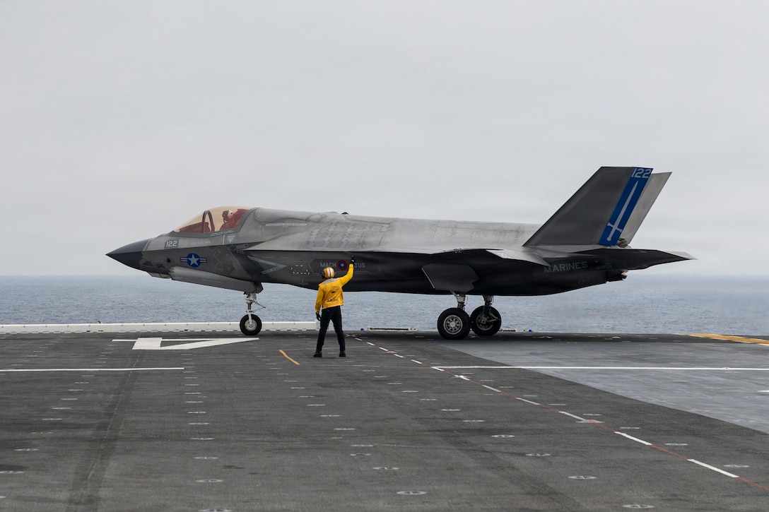 A U.S. Sailor assigned to Wasp-class amphibious assault ship USS Boxer (LHD 4), signals a U.S. Marine Corps F-35B Lightning II attached to Marine Fighter Attack Squadron (VMFA) 122, 11th Marine Expeditionary Unit during flight operations in the Pacific Ocean, March 21, 2026. The 11th MEU is currently underway aboard the Boxer Amphibious Ready Group in the U.S. 3rd Fleet area of operations demonstrating the United States’ long-term commitment to a free and open Indo-Pacific.