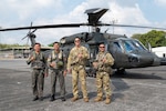 Philippine Air Force Sgt. Julius Chun Manasan, left, mechanic assigned to the 205th Tactical Helicopter Wing; U.S. Army 1st Sgt. Christopher Pacheco, center left, senior mechanic and standardization instructor assigned to the Hawaii Army National Guard; Philippine Air Force Lt. Col. John Paul Delgado, center, commander of the 210th Tactical Training Squadron; and U.S. Army Maj. John Worthington, right, Army Aviation Support Facility commander, standardization pilot and instrument examiner assigned to the Hawaii Army National Guard, pose for a photo in front of a Philippine Air Force S-70i Black Hawk helicopter during a Rotary Wing Subject Matter Expert Exchange Clark Air Base, Philippines, April 15, 2026. The exchange, conducted under the Department of War National Guard Bureau State Partnership Program, strengthens interoperability and reinforces the longstanding partnership between U.S. and Philippine forces through shared training and operational collaboration. Photo by Senior Master Sgt. Mysti Bicoy.