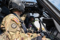 U.S. Army Maj. John Worthington, left, Army Aviation Support Facility commander, standardization pilot and instrument examiner assigned to the Hawaii Army National Guard, and Philippine Air Force Lt. Col. John Paul Delgado, right, commander of the 210th Tactical Training Squadron, prepare for a flight in a Philippine Air Force S-70i Black Hawk helicopter during a Rotary Wing Subject Matter Expert Exchange Clark Air Base, Philippines, April 15, 2026.