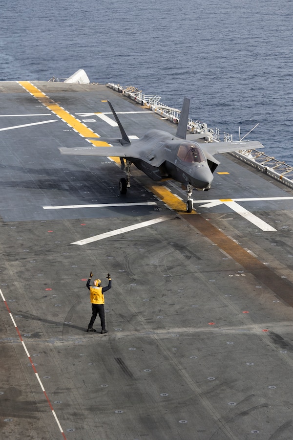 A U.S. Sailor assigned to Wasp-class amphibious assault ship USS Boxer (LHD 4), signals a U.S. Marine Corps F-35B Lightning II attached to Marine Fighter Attack Squadron (VMFA) 122, 11th Marine Expeditionary Unit during flight operations in the Pacific Ocean, March 22, 2026. The 11th MEU is currently underway aboard the Boxer Amphibious Ready Group in the U.S. 3rd Fleet area of operations demonstrating the United States’ long-term commitment to a free and open Indo-Pacific.
