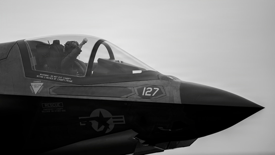 A U.S. Marine Corps F-35B Lightning II pilot with Marine Fighter Attack Squadron (VMFA) 122, 11th Marine Expeditionary Unit, signals to U.S. Sailors during flight operations aboard Wasp-class amphibious assault ship USS Boxer (LHD 4) in the Pacific Ocean, March 22, 2026. The 11th MEU is currently underway aboard the Boxer Amphibious Ready Group in the U.S. 3rd Fleet area of operations demonstrating the United States’ long-term commitment to a free and open Indo-Pacific.