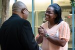 Tawanda Ford, a nurse with the Occupational Medicine department, speaks with Father Ignatius Madamere during the “Blessing of the Hands” ceremony at Navy Medicine Readiness and Training Command Cherry Point.
