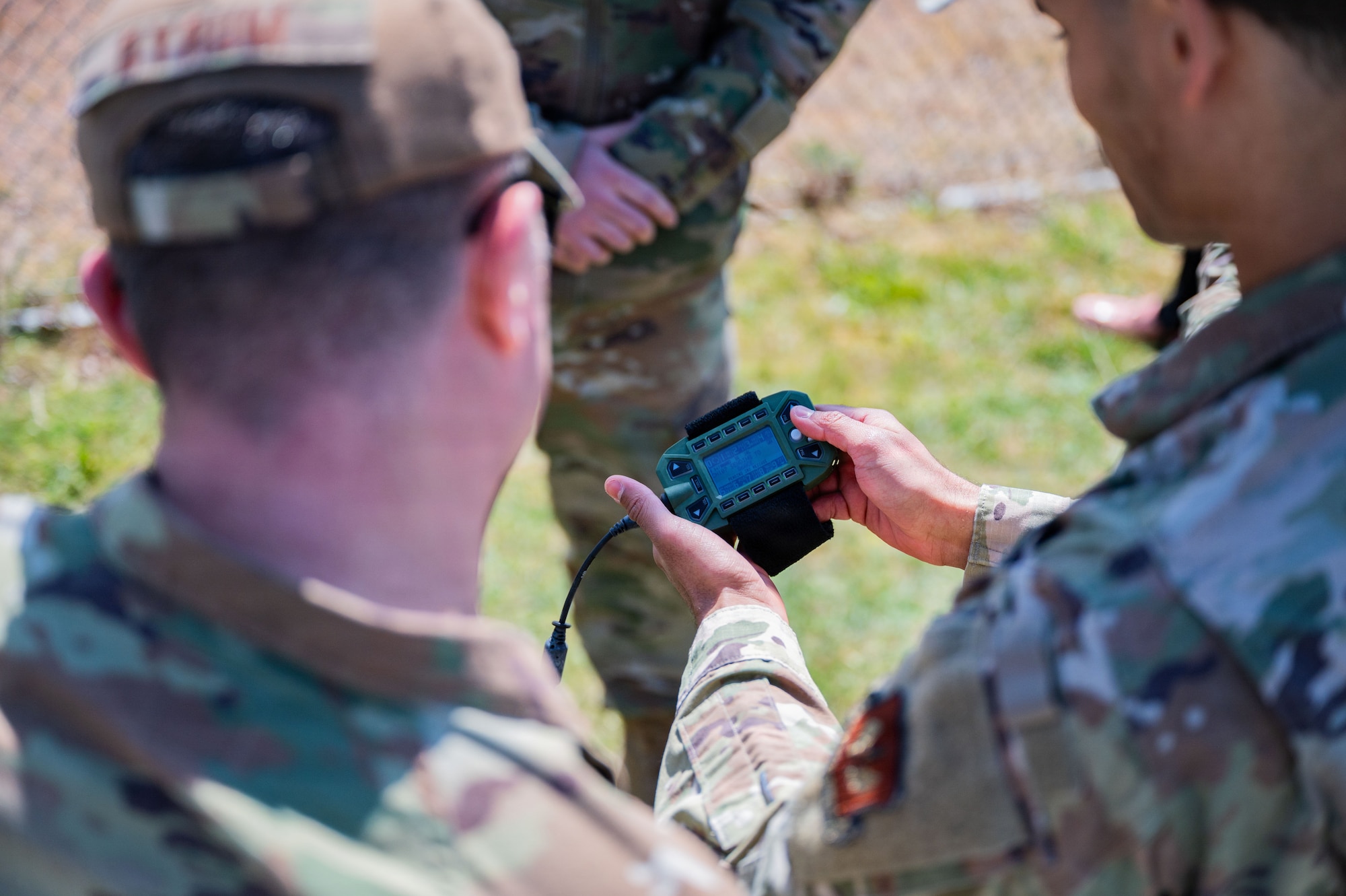 U.S. Air Force Senior Airman Savion Watson, 100th Communications Squadron agile combat employment technician, and Col. Steven Byrum, 100th Air Refueling Wing commander, read a screen from a PRC-160(V) radio during a day in the life integration at RAF Mildenhall, England, April 28, 2026.