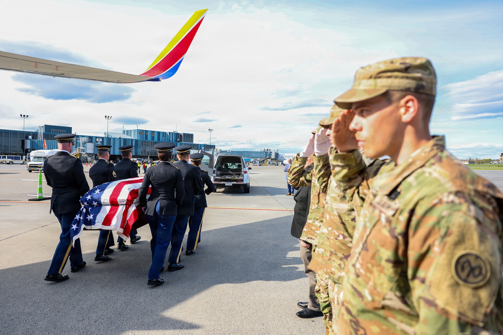 Soldiers assigned to the New York Army National Guard Honor Guard salute as the coffin containing the remains of Army Air Corps 2nd Lt. Joseph L. Burke are moved toward a hearse at Albany International Airport in Latham, New York, on May 1, 2026, during a dignified transfer of remains.