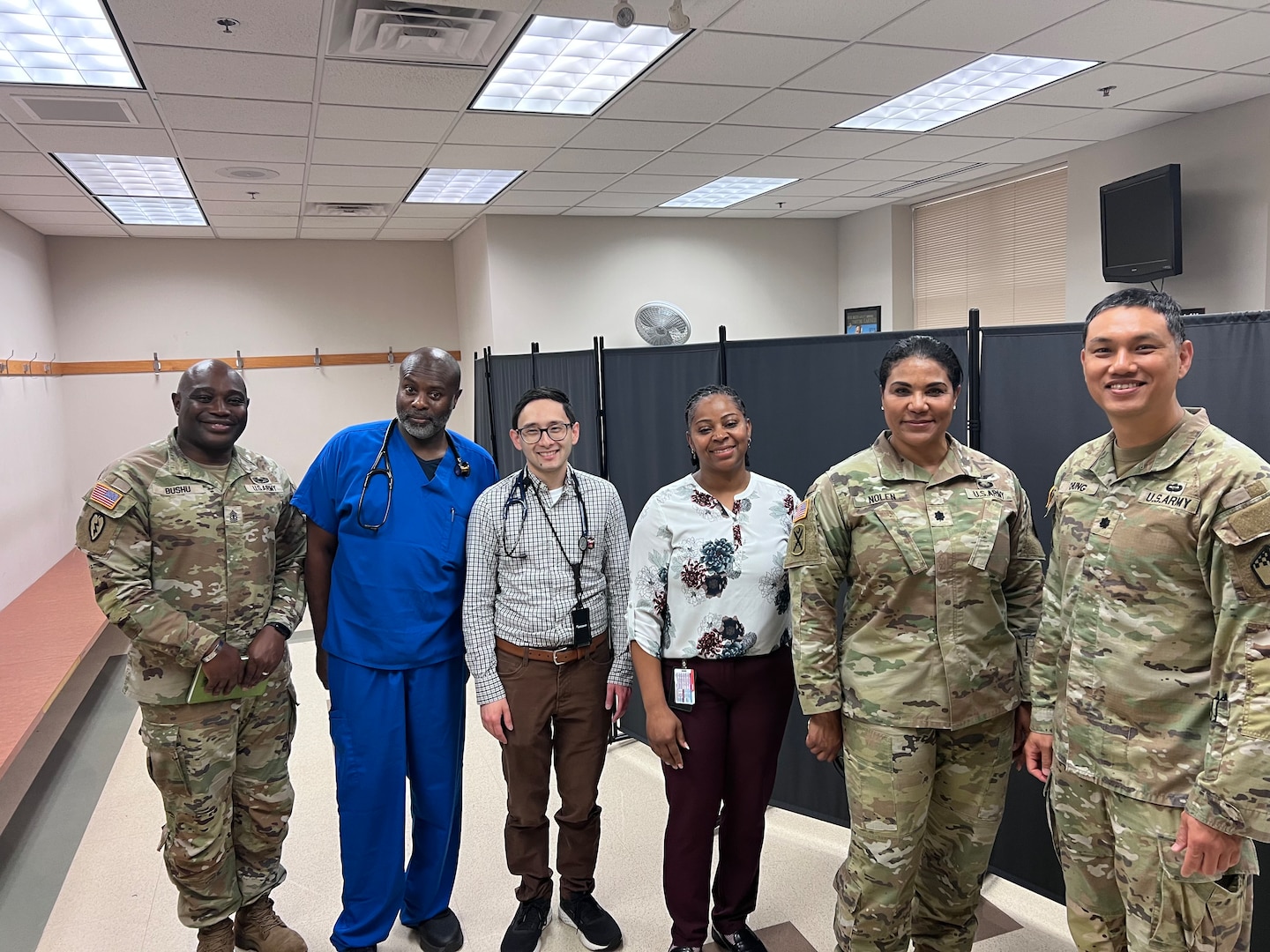 (L to R): 1SG Lemnyuy Bushu, 12th Battalion and Baltimore MEPS senior enlisted advisor, Dr. Jamey Cross, Eastern Sector Chief Medical Officer, Dr. Laurence Batmazian, Provider Quality Management Program, Angelia Moore, Fort Lee MEPS physician assistant, Army Lt. Col. Angela Nolen, physician assistant, Lt. Col. Chung, 12th Battalion and Baltimore MEPS commander pose for a photo between seeing applicants during the Capacity Augmentation Team initiative. USMEPCOM's first full Capacity Augmentation Team initiative took place Apr. 28-30, achieving a 70% increase in maximum daily capacity/allocation.