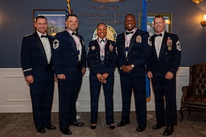 5 Airmen in mess dress pose for a group photo