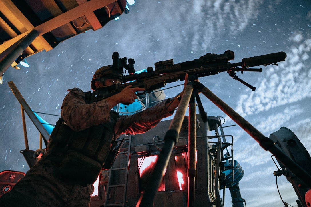 U.S. Marine Corps Sgt. Yoel Rhe, a scout team leader with Weapons Company, Battalion Landing Team 3/5, 11th Marine Expeditionary Unit, scans for vessels aboard Wasp-class amphibious assault ship USS Boxer (LHD 4) while transiting the Surigao Strait, April 26, 2026.
