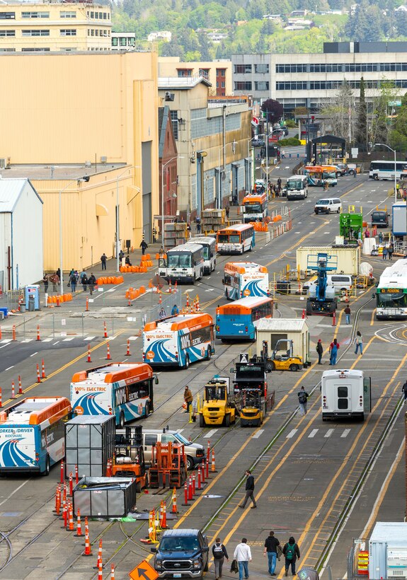 Worker/Driver buses line Farragut Avenue picking up command employees along the way in preparation for the afternoon commute at Puget Sound Naval Shipyard & Intermediate Maintenance Facility, in Bremerton, Washington, April 23, 2026. Alternative transportation options offered by local transit agencies are available for free to eligible PSNS & IMF employees through the Federal Transportation Incentive Program. (U.S. Navy photo by Wendy Hallmark)