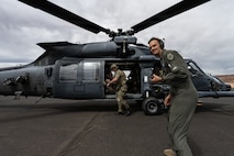 people standing by helicopter