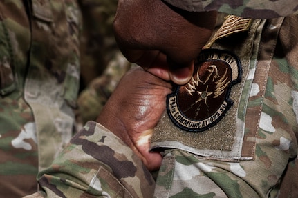 A member of the U.S. Air Force’s 794th Communications Squadron applies a new unit patch to an Airman from the 690th Intelligence Support Squadron during a mission

transfer ceremony on Joint Base Anacostia-Bolling, Washington, D.C., May 1, 2026. The ceremony highlighted the merger of the two squadrons and featured patch-swapping between 20 personnel from both units. (U.S. Air Force photo by Senior Airman Shanel Toussaint)