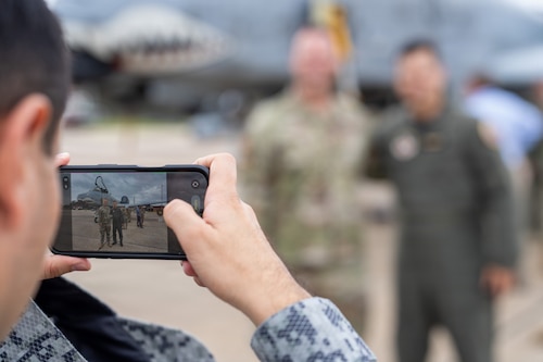 A National Security Forum and Gathering of Eagles attendee takes a photo with Airmen during an Airpower demonstration at Maxwell Air Force Base, Alabama, May 6, 2026.
