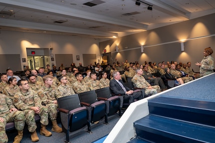 U.S. Air Force Airmen listen to their new acting commander, U.S. Air Force Col. Jontae McGrew, commander of the 844th Communications Group, during a mission transfer ceremony for the 690th Intelligence Support Squadron merger with the 794th Communications Squadron on Joint Base Anacostia-Bolling, Washington, D.C., May 1, 2026. Combined members from both units will form a new flight, 794th Cyber Protection, to provide increased technological capabilities to the National Capital Region.