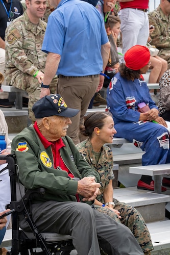 A Gathering of Eagles attendee and U.S. Marine observe an Airpower demonstration during National Security Forum and Gathering of Eagles events at Maxwell Air Force Base, Alabama, May 6, 2026.
