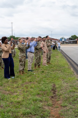 National Security Forum and Gathering of Eagles attendees record the F-22 Demonstration Team aerial performance during an Airpower demonstration at Maxwell Air Force Base, Alabama, May 6, 2026.