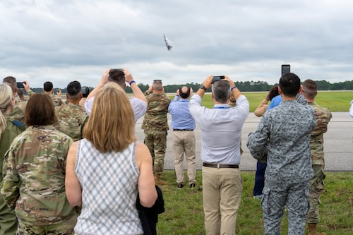 National Security Forum and Gathering of Eagles attendees record an F-22 Demonstration Team aerial performance during an Airpower demonstration at Maxwell Air Force Base, Alabama, May 6, 2026.