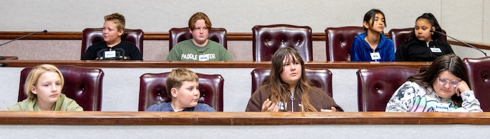 Braylee, jury foreperson, prepares to read the verdict alongside Capt. Matthew Norwood during a fairy tale mock trial at Edwards Air Force Base, California, April 21. Norwood, 412th Test Wing Judge Advocate office, guided the eight-student jury through the deliberation process to highlight the importance of due process.