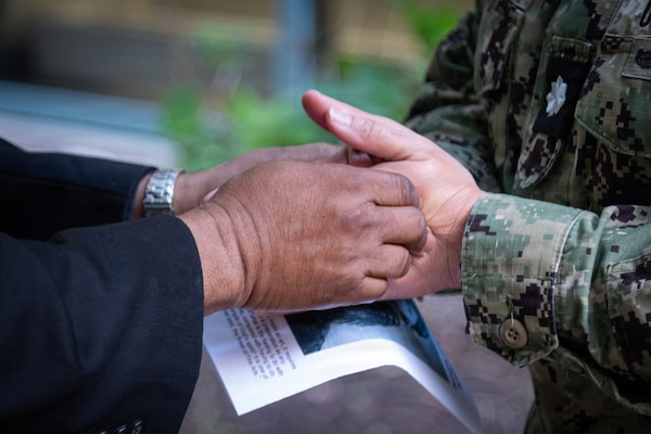 Father Ignatius Madamere blesses the hands of Cmdr. Stacey Swindells during a “Blessing of the Hands” ceremony conducted Wednesday, May 6, 2026 aboard Navy Medicine Readiness & Training Command Cherry Point.  Swindells serves as head of the facility’s Healthcare Business team.

Led by Navy Chaplain Lt. Cmdr. Daniel Bruno and Madamere, the ceremony served as an opening to National Nurses Week aboard the clinic, which runs from Wednesday, May 6 to Tuesday May 12.