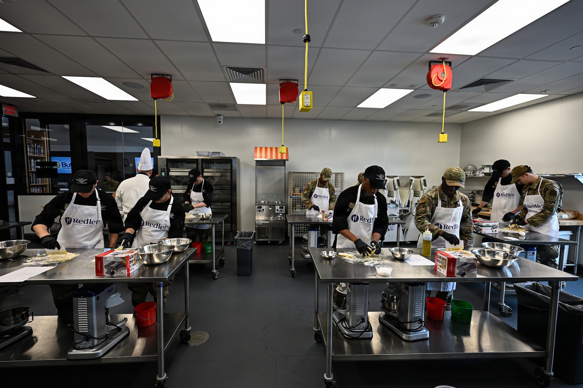 22nd Force Support Squadron dining facility Airmen prepare dough for a pasta recipe at the Redler Institute of Culinary Arts in Andover, Kansas, April 28, 2026. The DFAC Airmen participated in a partnered program between Redler and McConnell Air Force Base designed to teach them new culinary skills. (U.S. Air Force photo by Senior Airman Amelio Brown)