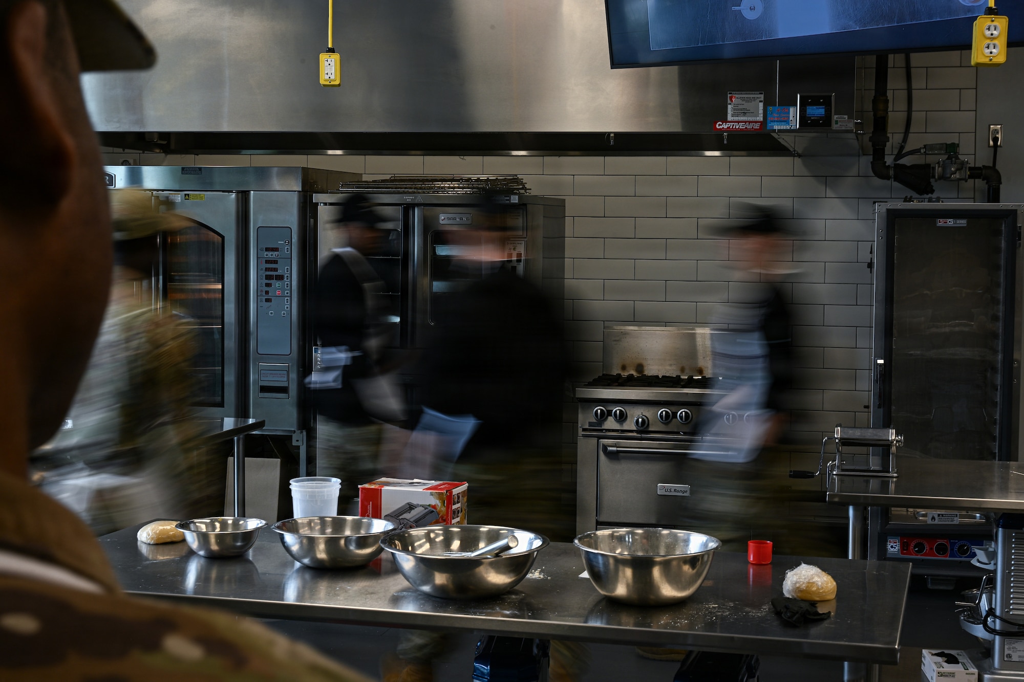 22nd Force Support Squadron Airmen traverse the kitchen of the Redler Institute of Culinary Arts in Andover, Kansas, April 28, 2026. Airmen participated in a partnered program between Redler and McConnell Air Force Base designed to teach them new culinary skills. (U.S. Air Force photo by Senior Airman Amelio Brown)