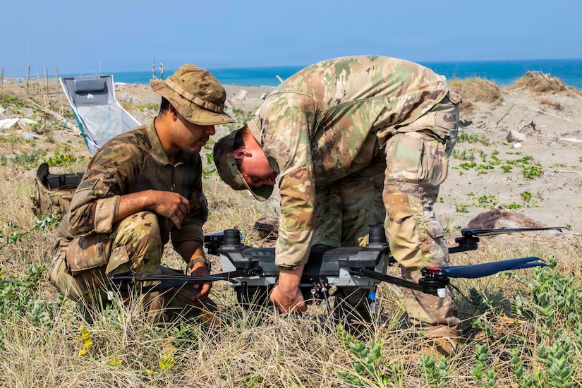 U.S. Army Spc. Timothy Trevino (left) and Pfc. Jared Baffa (right), both infantrymen assigned to 2nd Battalion, 35th Infantry Regiment, 3rd Mobile Brigade, 25th Infantry Division, connect the battery of a PDW C100 Heavy-Lift Quadcopter drone during a hands on training lane as part of Exercise Balikatan 2026 in Laoag City, Philippines, April 25, 2026.