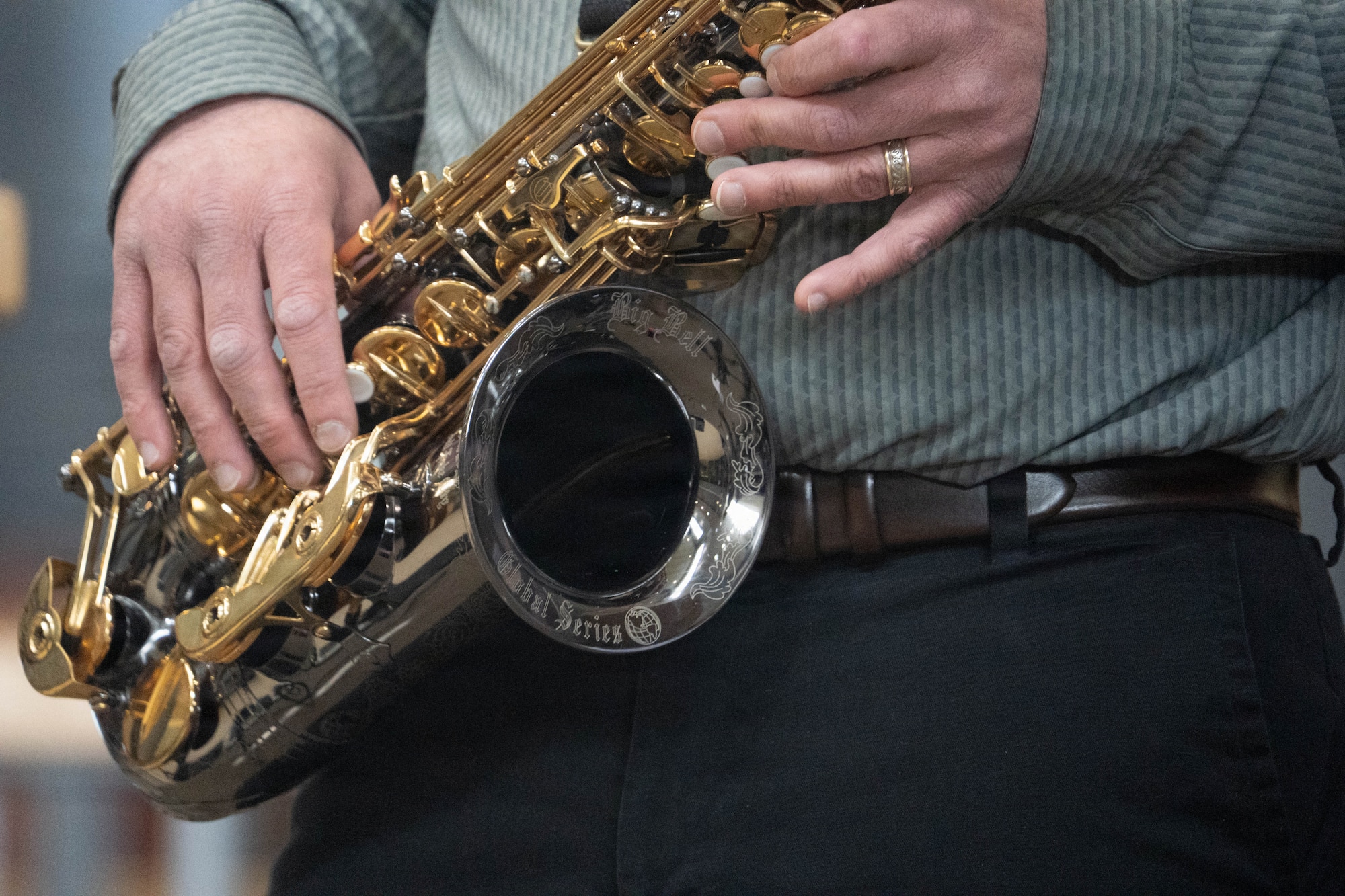 A music teacher plays the saxophone during a class led by the U.S. Air Force Band of the Pacific-Hawaii in Eagle River, Alaska, April 22, 2026. The collaborative session allowed students to see their instructor perform with professional military musicians, highlighting the partnership between the military and its local communities. (U.S. Air Force photo by Airman 1st Class Keola Vischi)