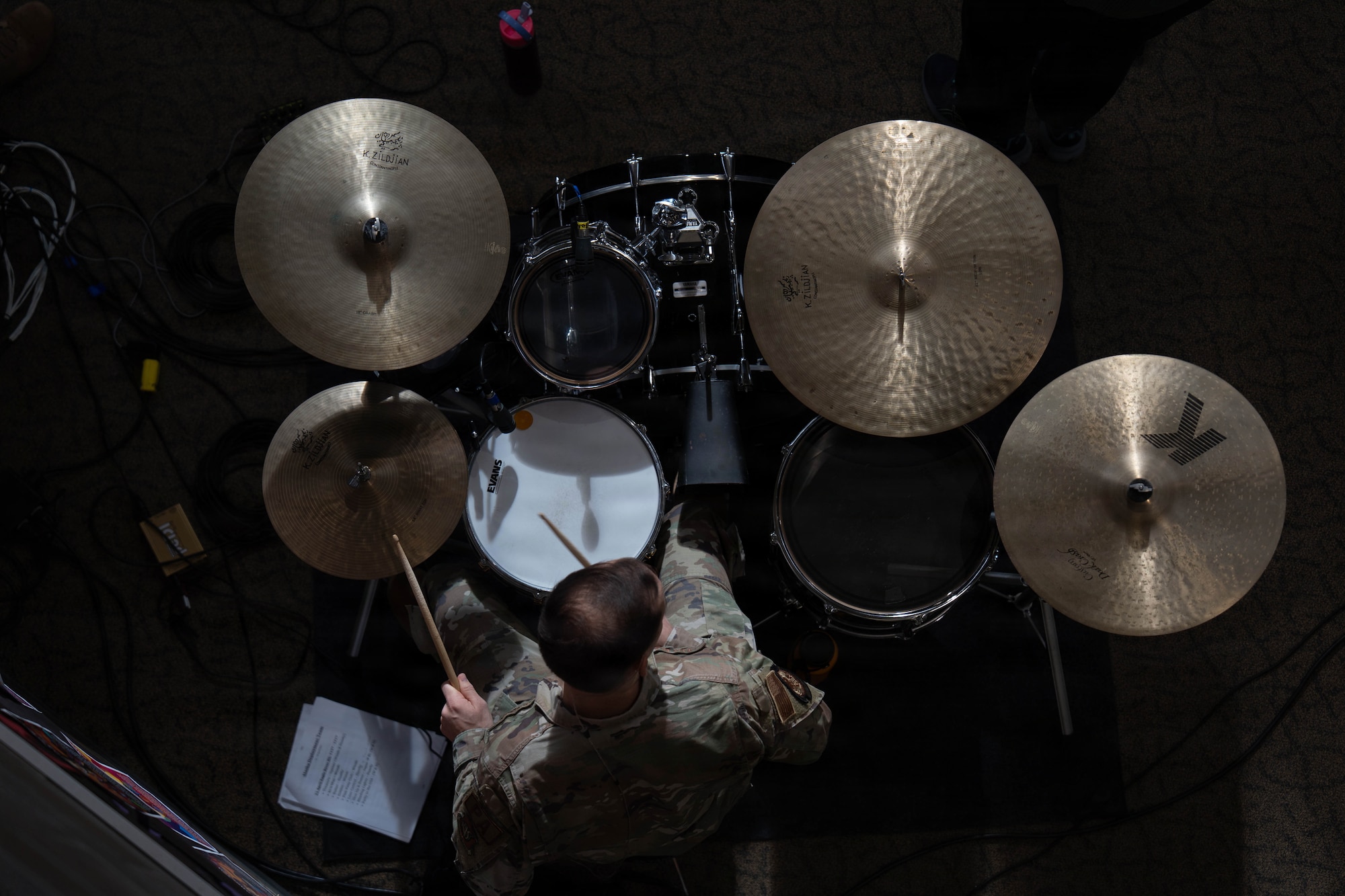 A drummer with the U.S. Air Force Band of the Pacific-Hawaii performs during a community outreach concert at Eagle River High School in Eagle River, Alaska, April 22, 2026. The performance was part of a statewide tour aimed at strengthening community ties, supporting military families, and providing professional mentorship to music students within the Anchorage School District. (U.S. Air Force photo by Airman 1st Class Keola Vischi)
