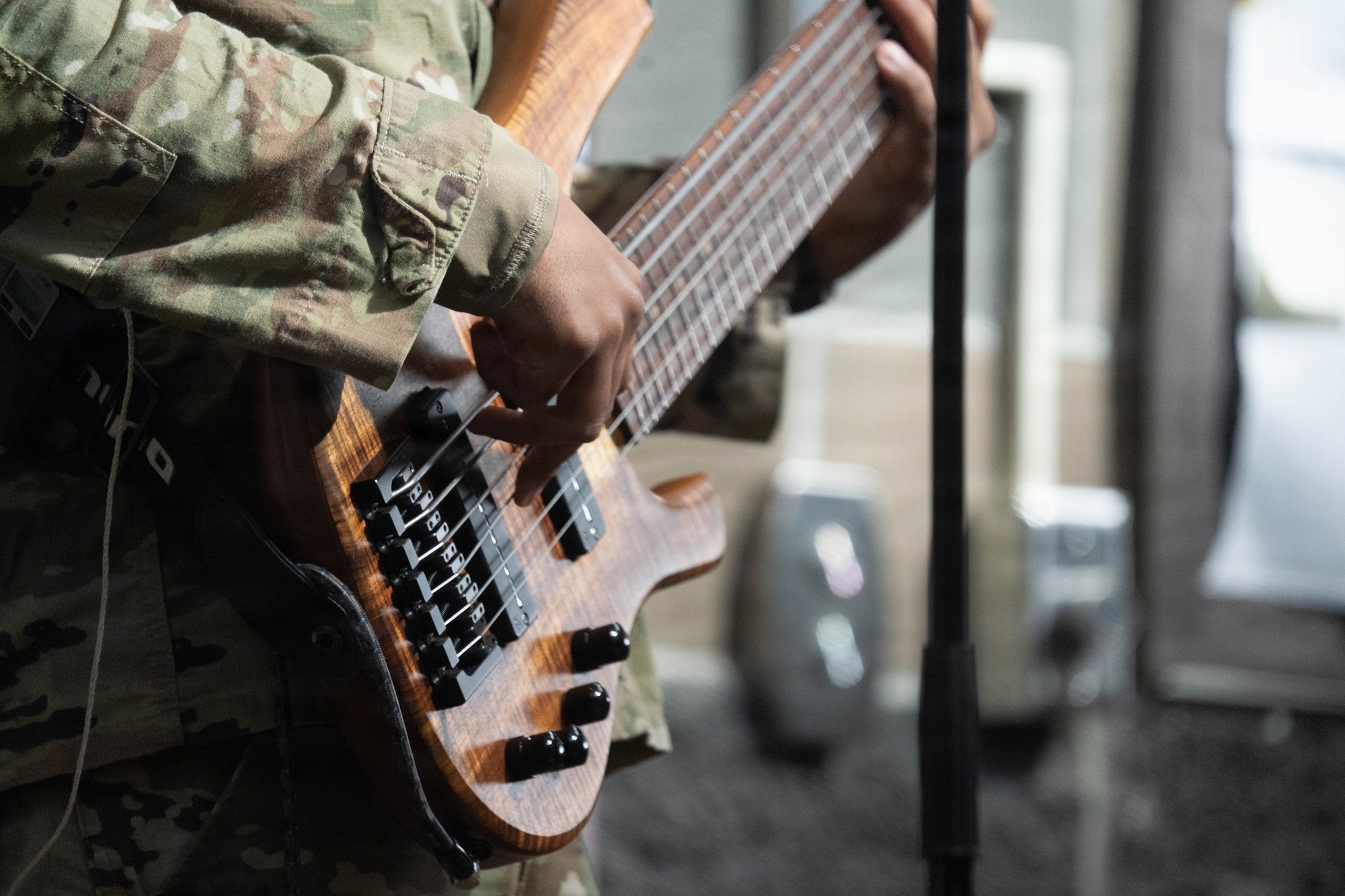 A bass guitarist with the U.S. Air Force Band of the Pacific-Hawaii, performs for students during a live concert at Eagle River High School in Eagle River, Alaska, April 22, 2026. The band’s visit to the school provided a platform for professional musicians to demonstrate technical proficiency and engage with students, reinforcing the Air Force's commitment to community outreach and youth mentorship in the Anchorage area. (U.S. Air Force photo by Airman 1st Class Keola Vischi)
