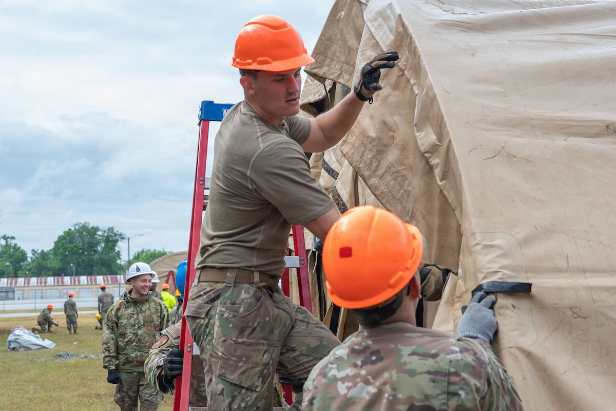 Airmen construct a tent