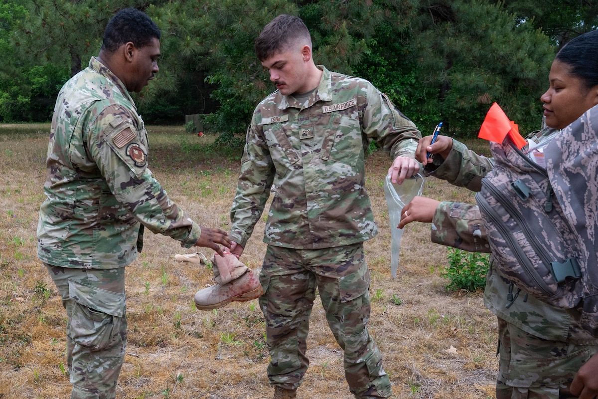 Airmen put a combat boot in a plastic bag