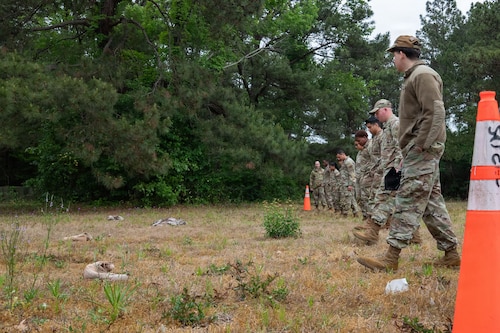 A group of Airmen walk in a straight line