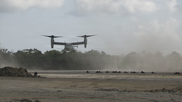 U.S. Marines assigned to 1st Battalion, 5th Marine Regiment, Marine Rotational Force – Darwin, hold security as an MV-22B Osprey, assigned to Marine Medium Tiltrotor Squadron 268, approaches the flightline during an airfield seizure as a part of Exercise Balikatan 2026 at Balabac Island, Philippines, May 3, 2026.