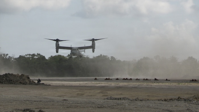 U.S. Marines assigned to 1st Battalion, 5th Marine Regiment, Marine Rotational Force – Darwin, hold security as an MV-22B Osprey, assigned to Marine Medium Tiltrotor Squadron 268, approaches the flightline during an airfield seizure as a part of Exercise Balikatan 2026 at Balabac Island, Philippines, May 3, 2026.